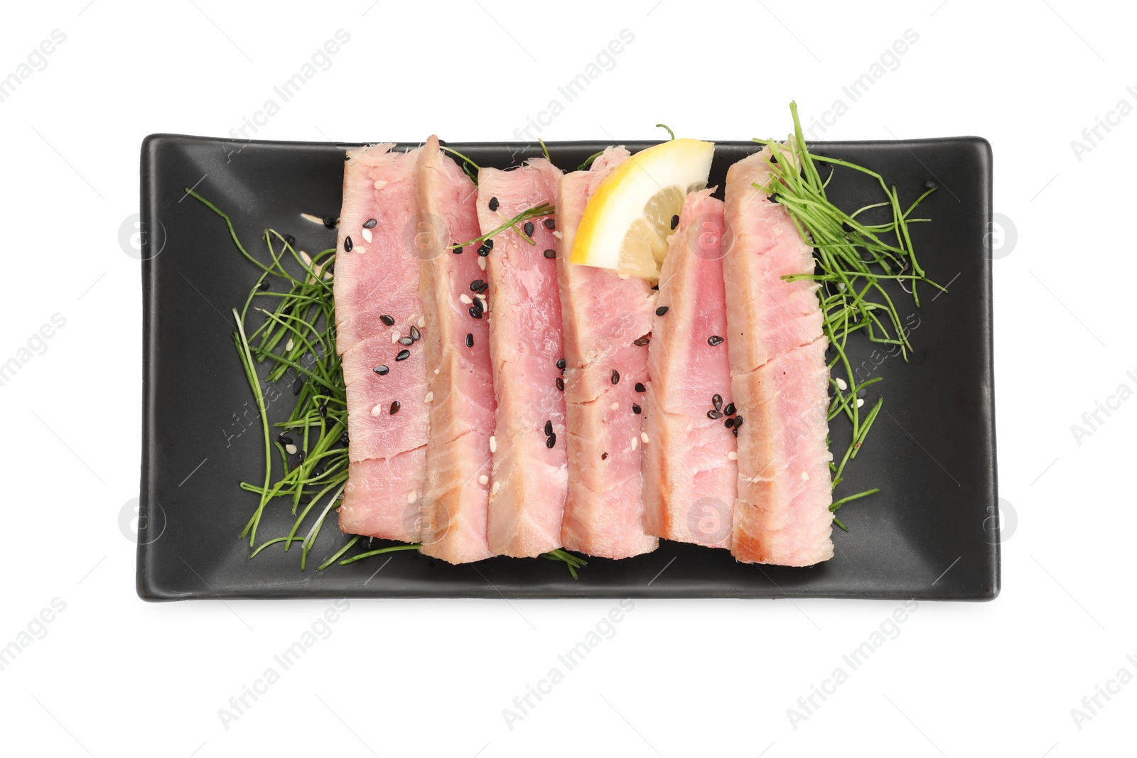 Photo of Pieces of delicious tuna steak with microgreens and lemon isolated on white, top view