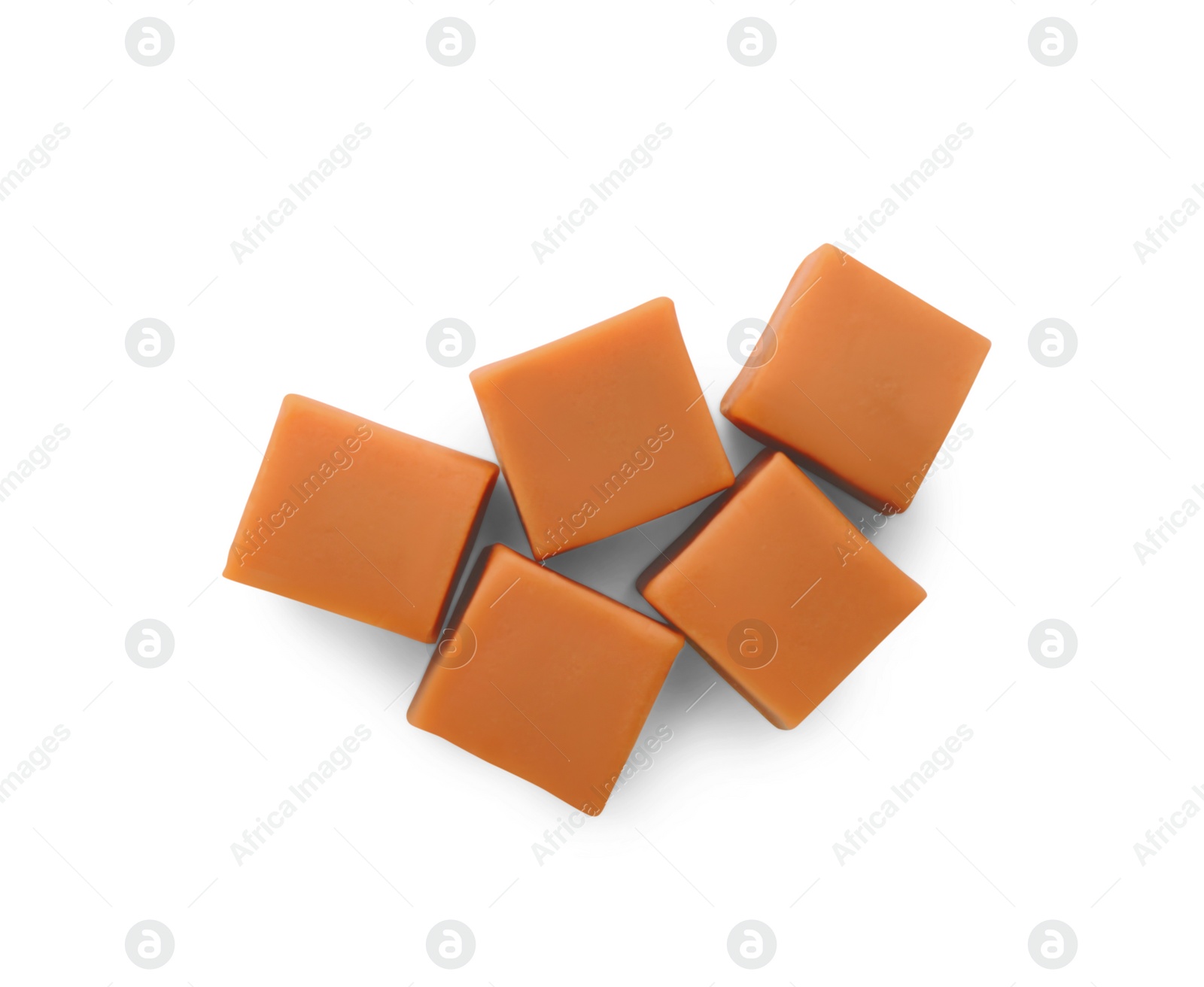 Photo of Heap of caramel candies on white background, top view