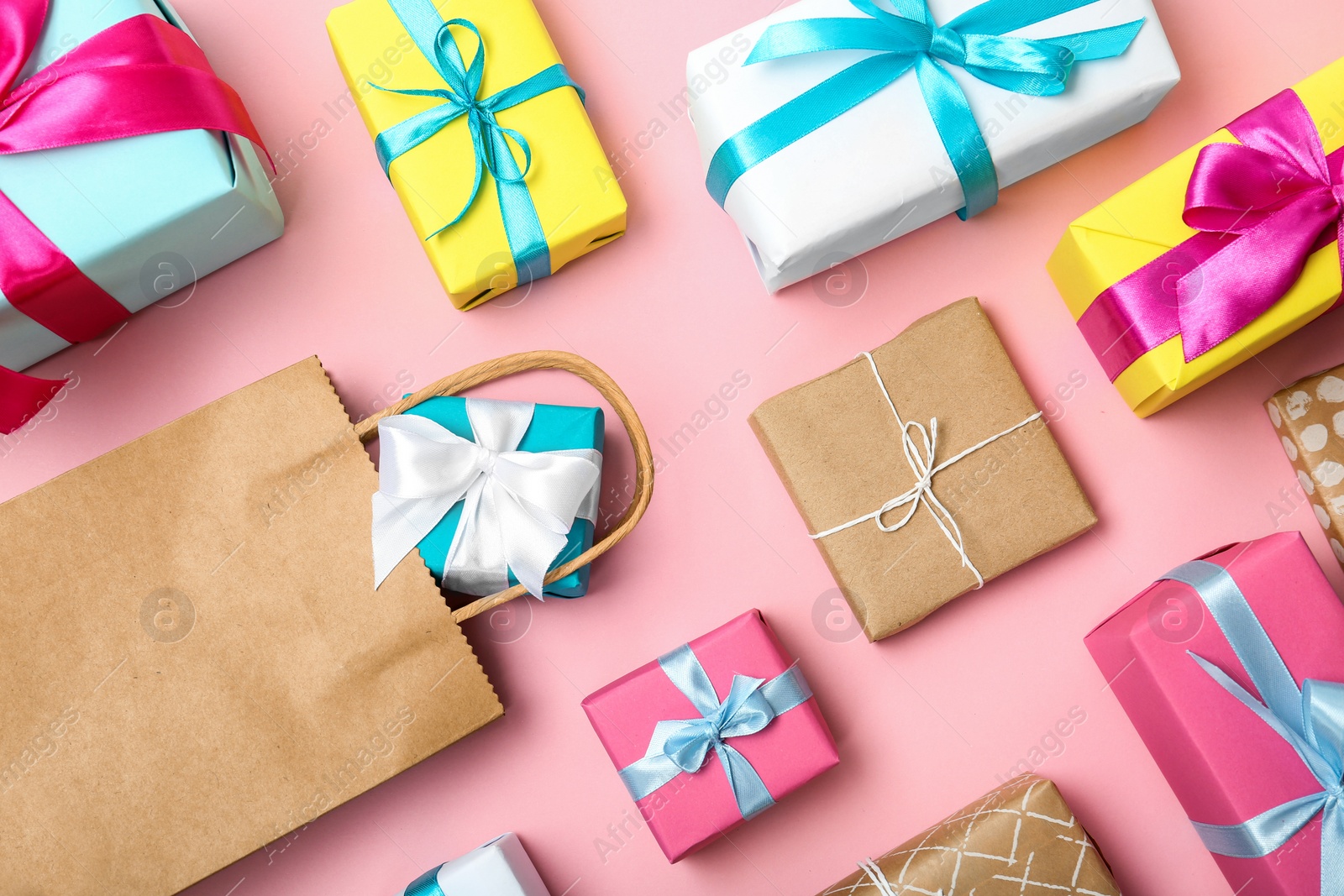 Photo of Flat lay composition with shopping bag and gifts on color background