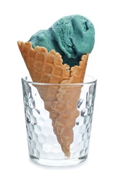 Photo of Spirulina ice cream cone in glass on white background