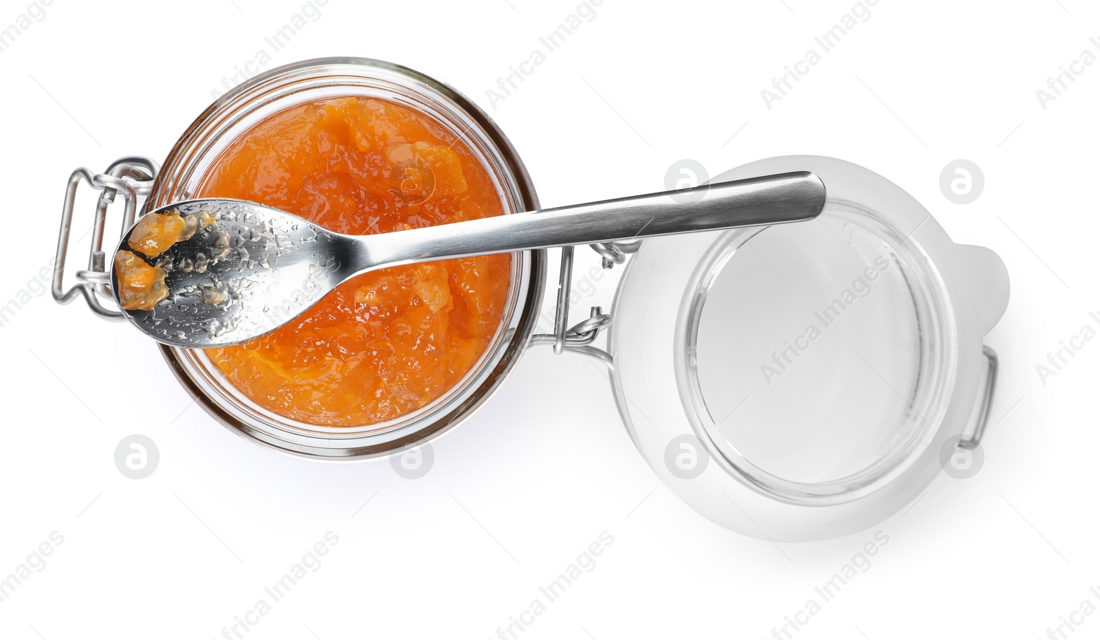 Photo of Jar with peach jam and spoon on white background