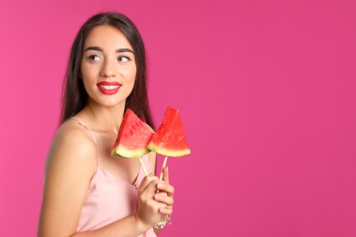 Photo of Beautiful young woman posing with watermelon on color background