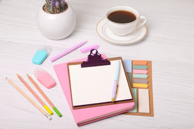 Photo of To do notes, planner, stationery and coffee on white wooden table