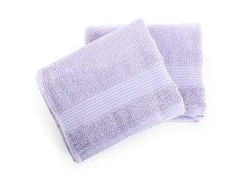 Photo of Folded violet terry towels isolated on white, top view
