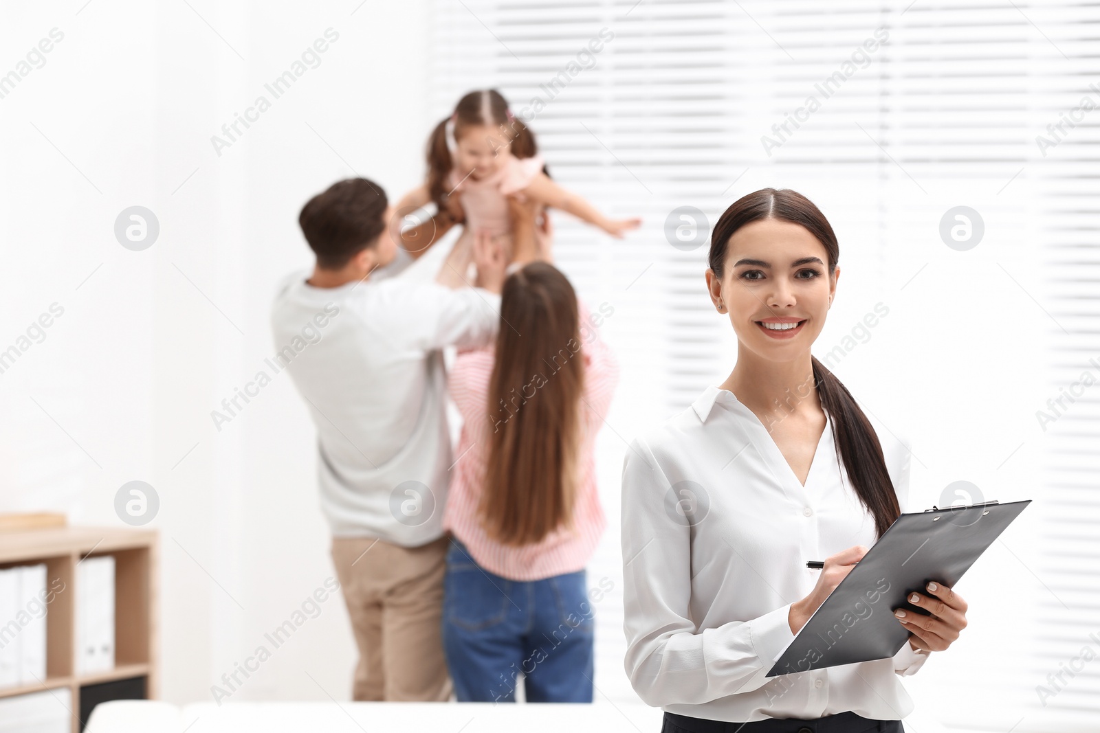 Photo of Professional psychologist and happy family in office