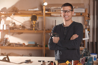 Professional carpenter with set of tools in workshop