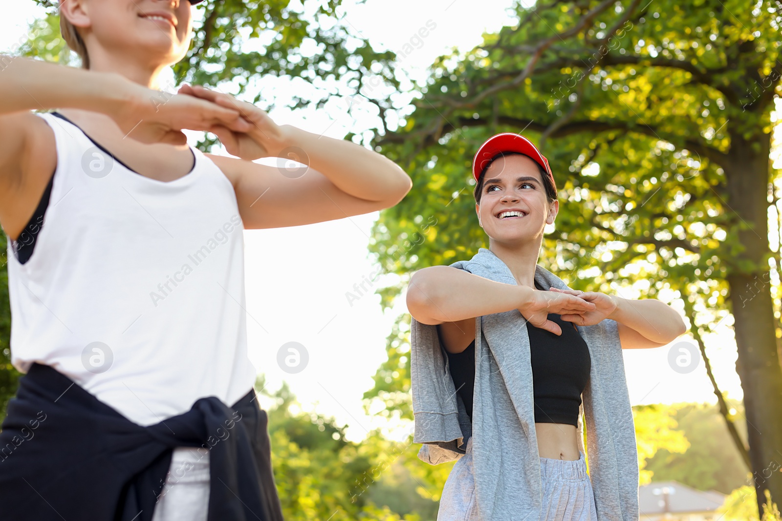 Photo of Women doing morning exercise in park on sunny day