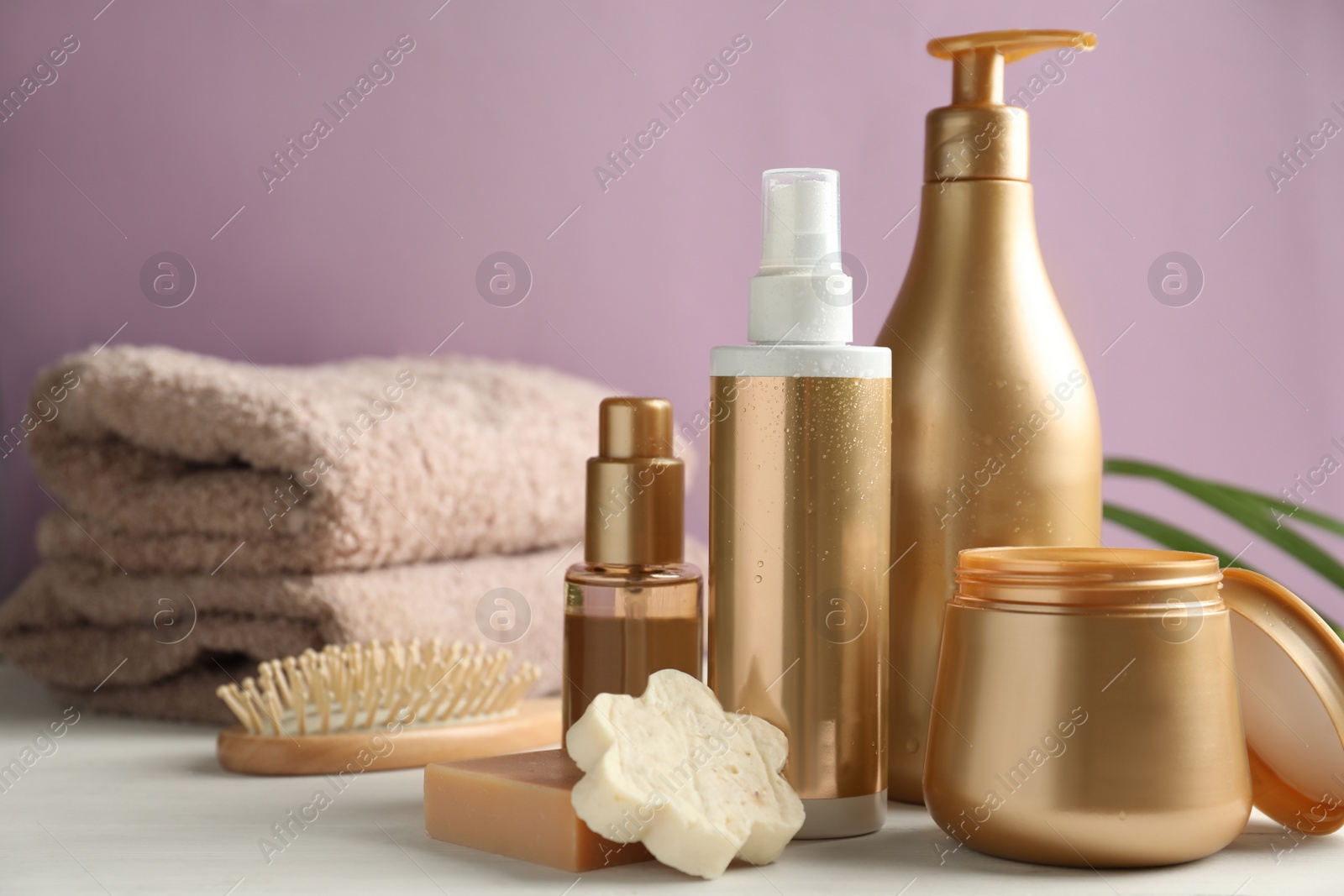 Photo of Composition with hair care cosmetic products on white table. Space for text