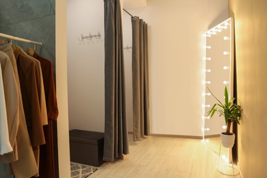 Photo of Dressing rooms in fashion store. Interior design