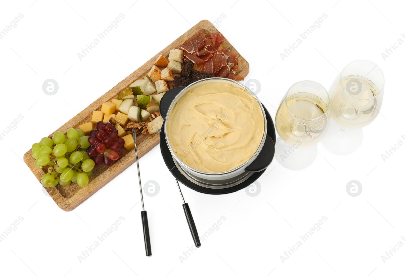 Photo of Fondue with tasty melted cheese, forks, different snacks and wine isolated on white, top view