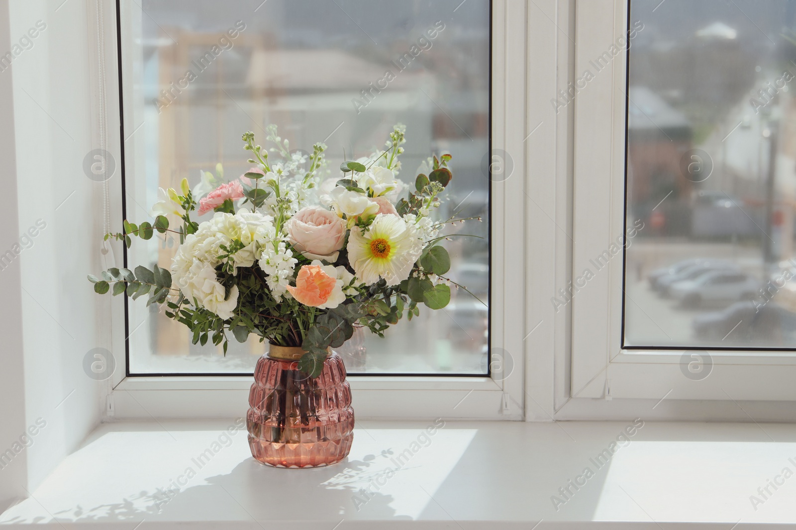 Photo of Bouquet of beautiful flowers on windowsill indoors. Space for text