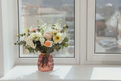 Photo of Bouquet of beautiful flowers on windowsill indoors. Space for text