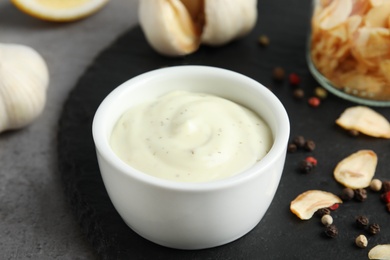 Photo of Bowl of garlic sauce on slate plate