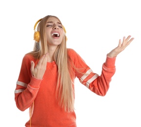 Beautiful young woman listening to music with headphones on white background