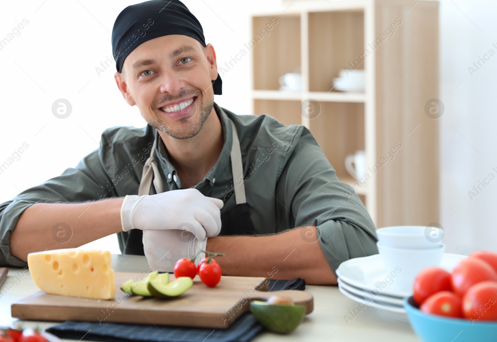 Photo of Professional chef in uniform working at restaurant kitchen