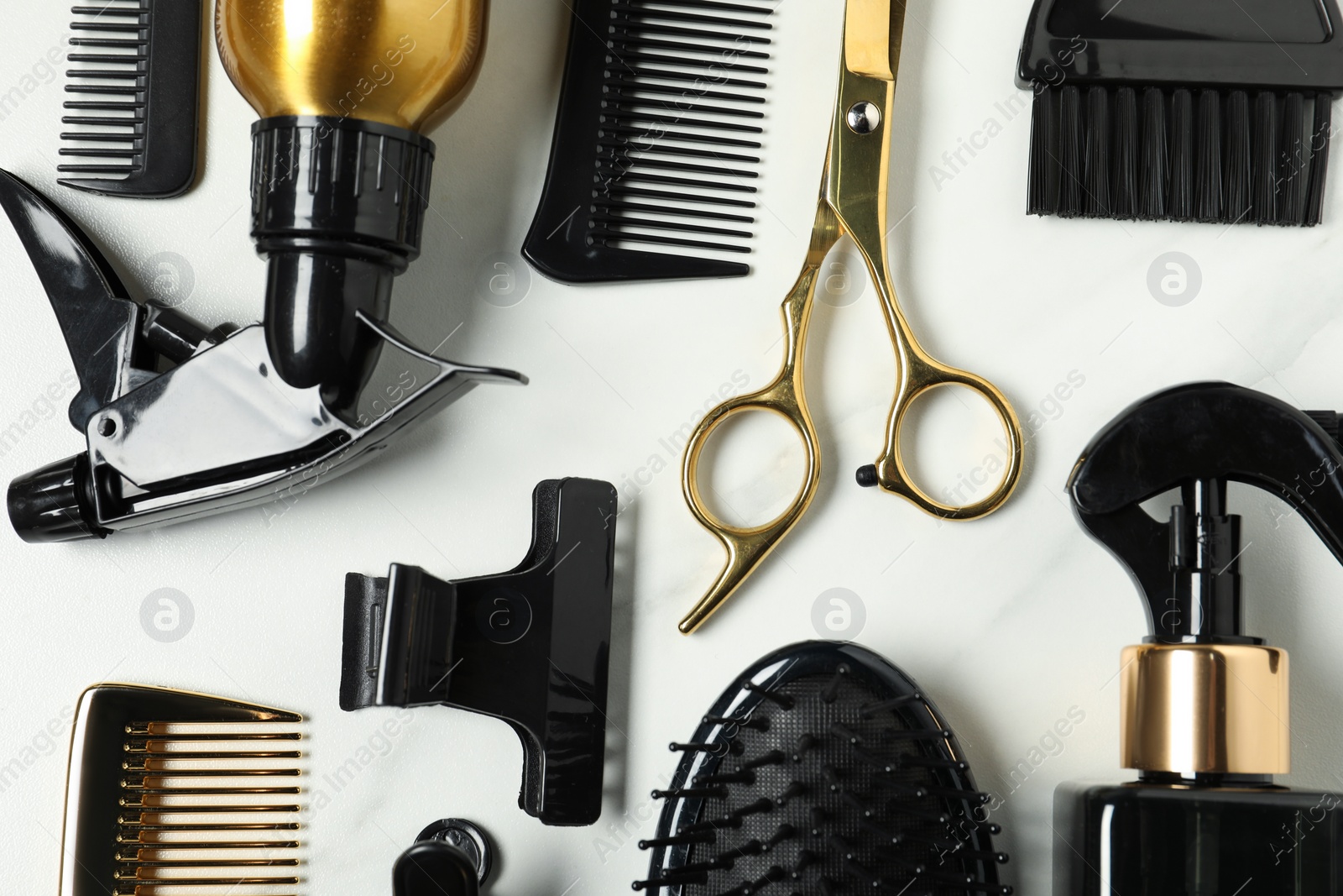 Photo of Hairdressing tools on white table, flat lay