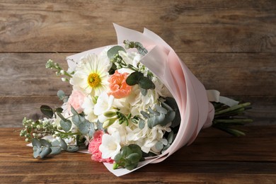 Bouquet of beautiful flowers on wooden table