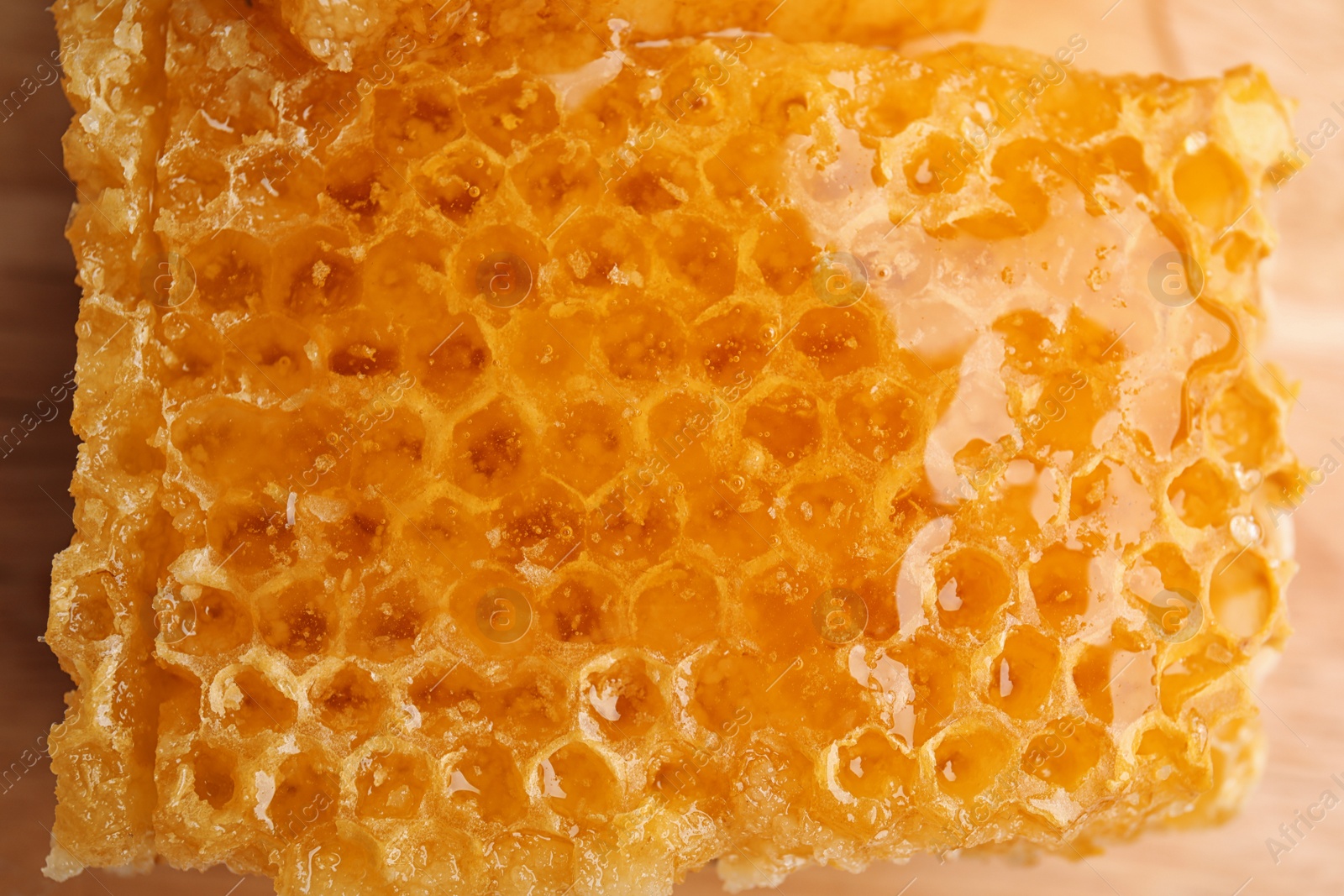 Photo of Closeup view of delicious sweet honeycomb on table