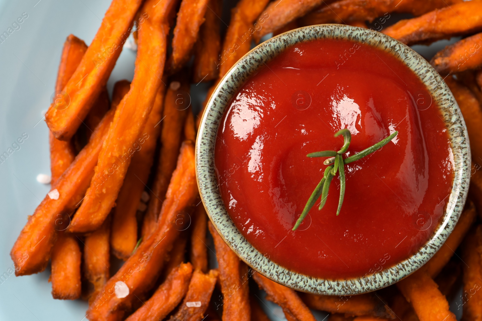 Photo of Plate with delicious sweet potato fries and sauce, closeup