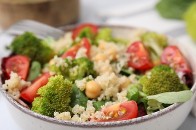 Photo of Healthy meal. Tasty salad with quinoa, chickpeas and vegetables in bowl, closeup