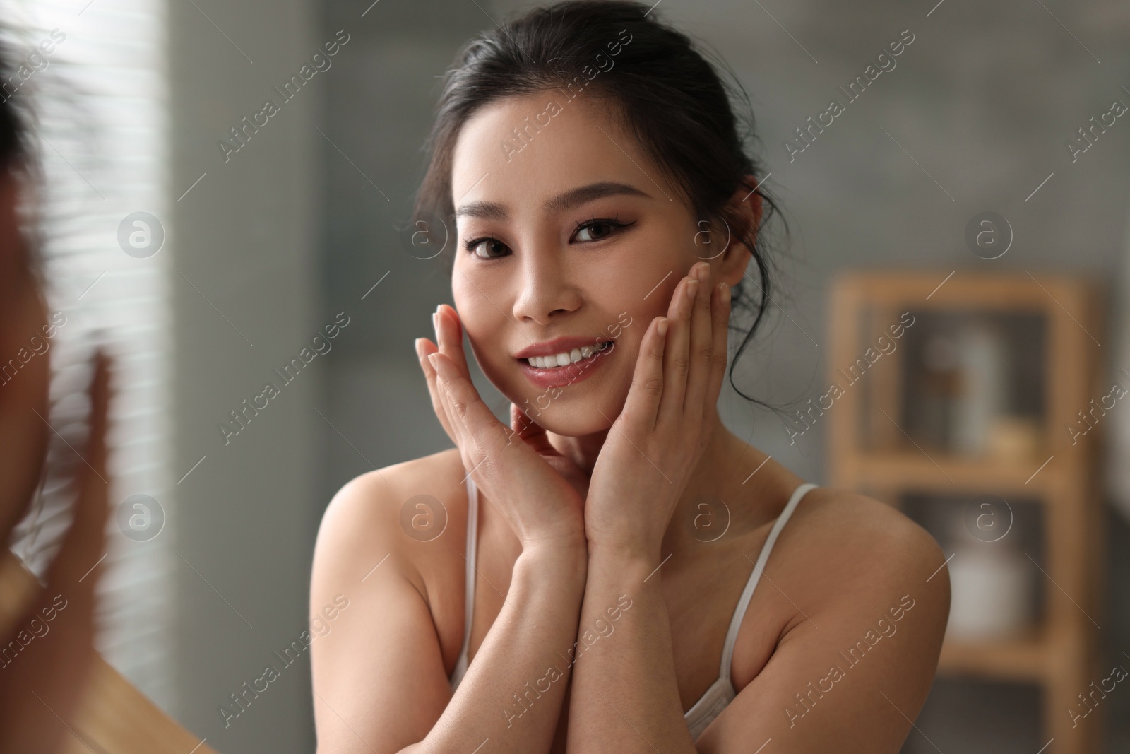 Photo of Portrait of beautiful woman indoors, view through mirror