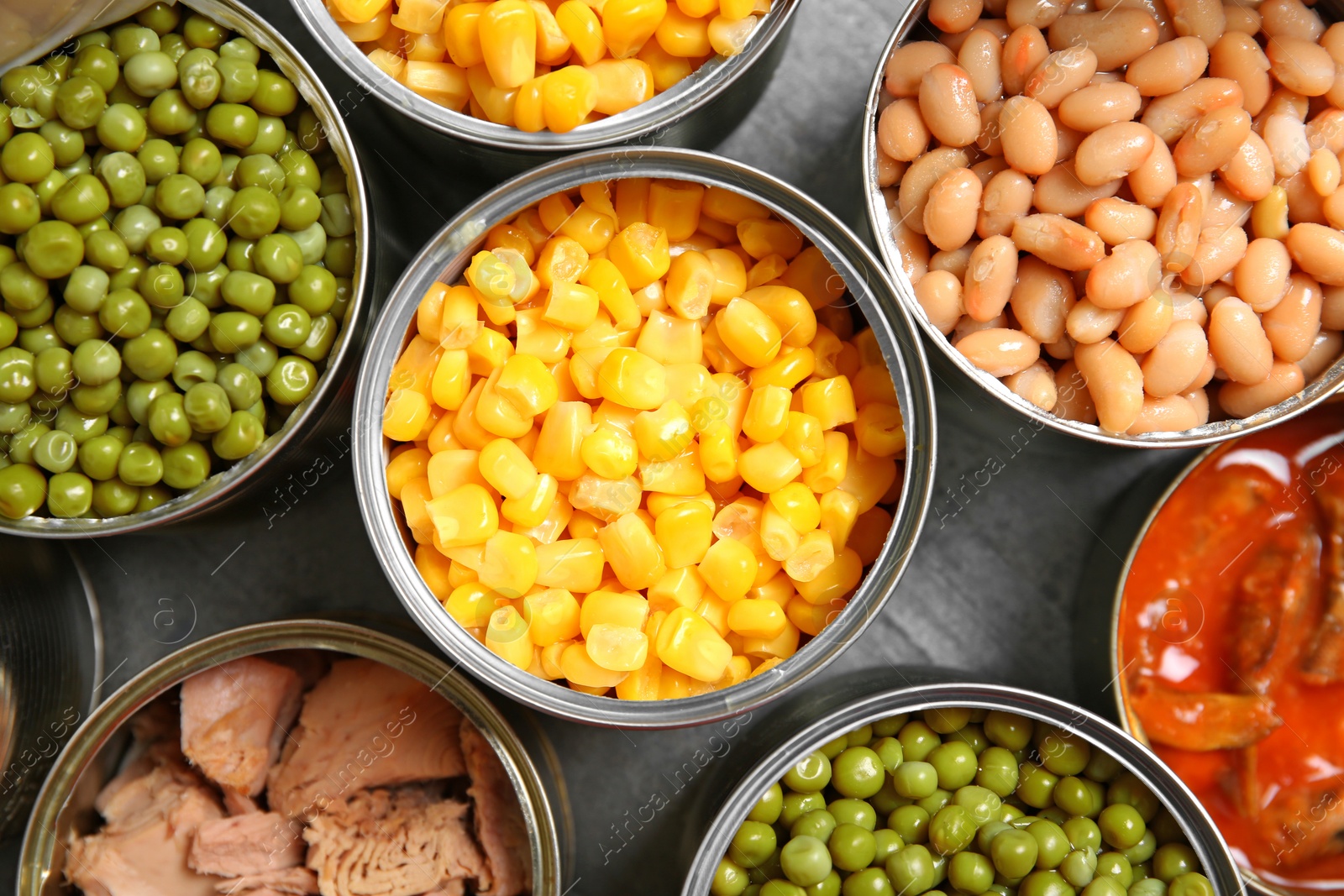 Photo of Open tin cans of conserved products, top view