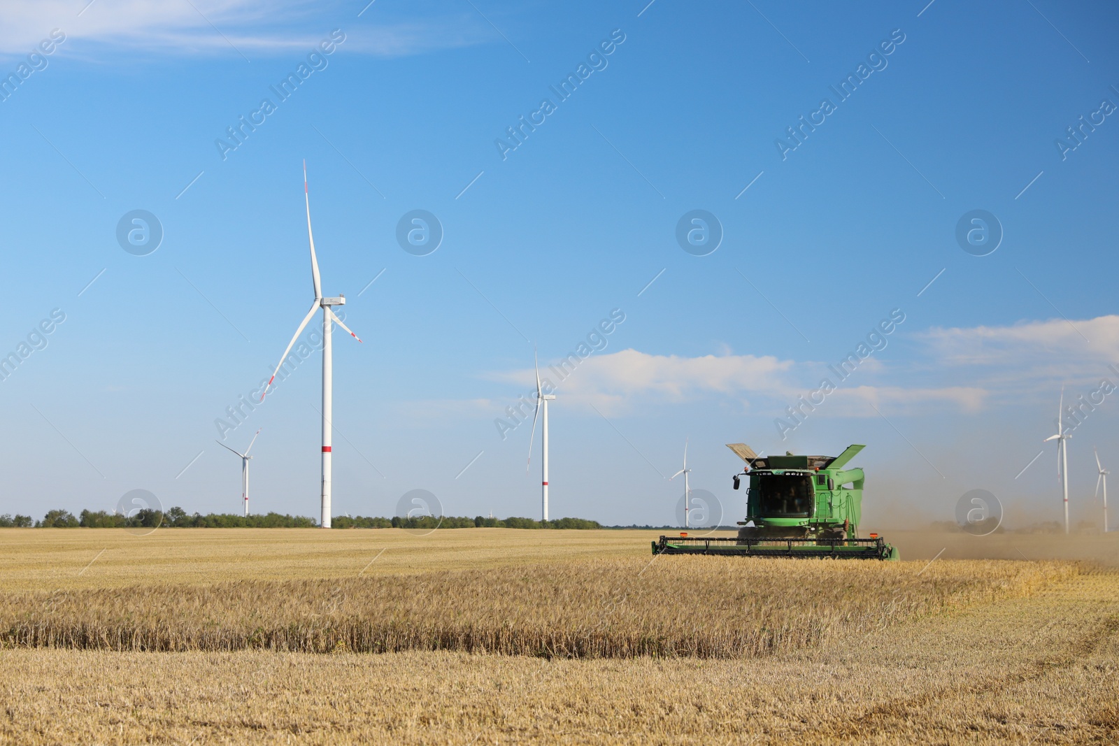 Photo of Modern combine harvester working in agricultural field