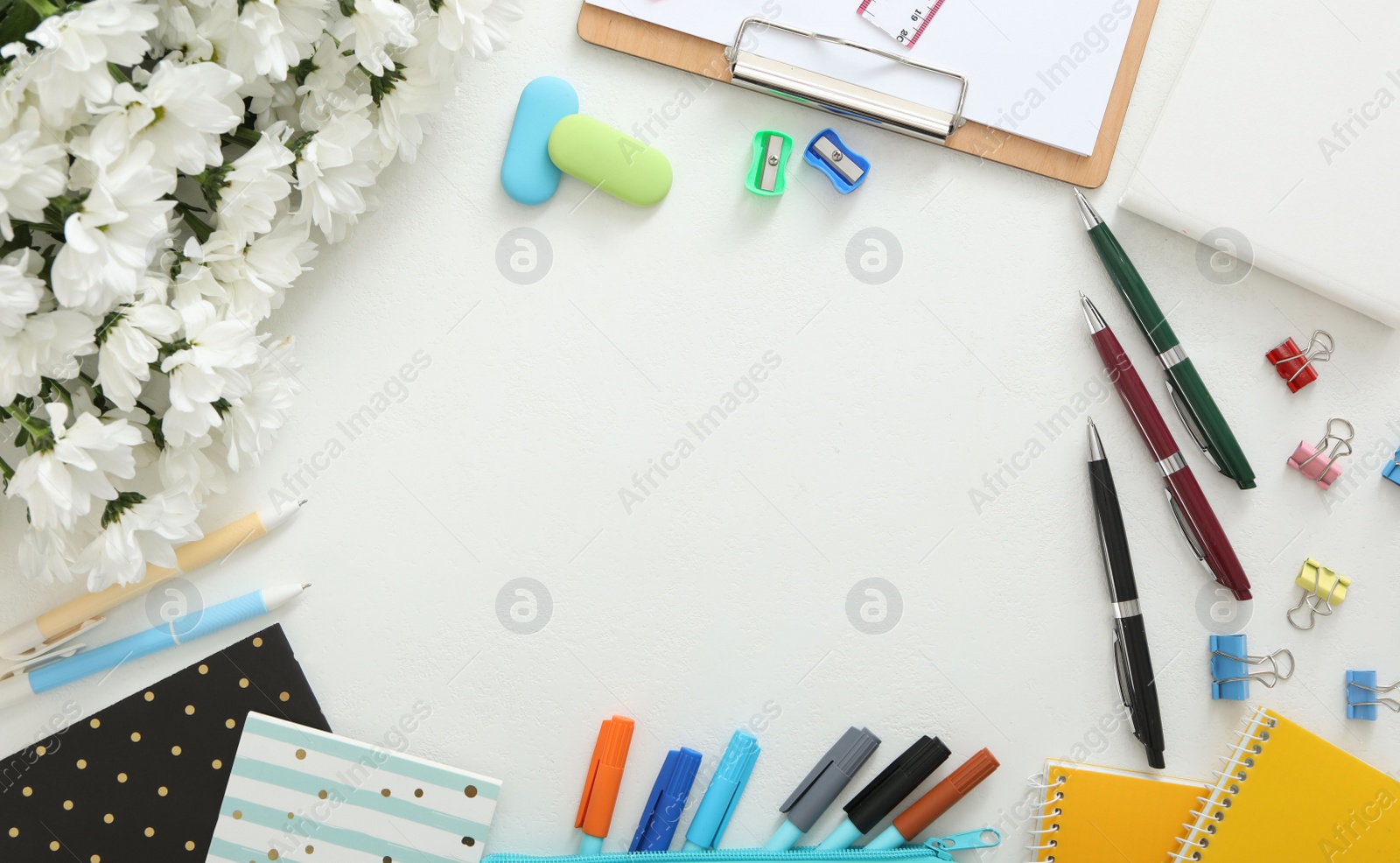Photo of Frame made of flowers and stationery on white background, flat lay with space for text. Teacher's Day