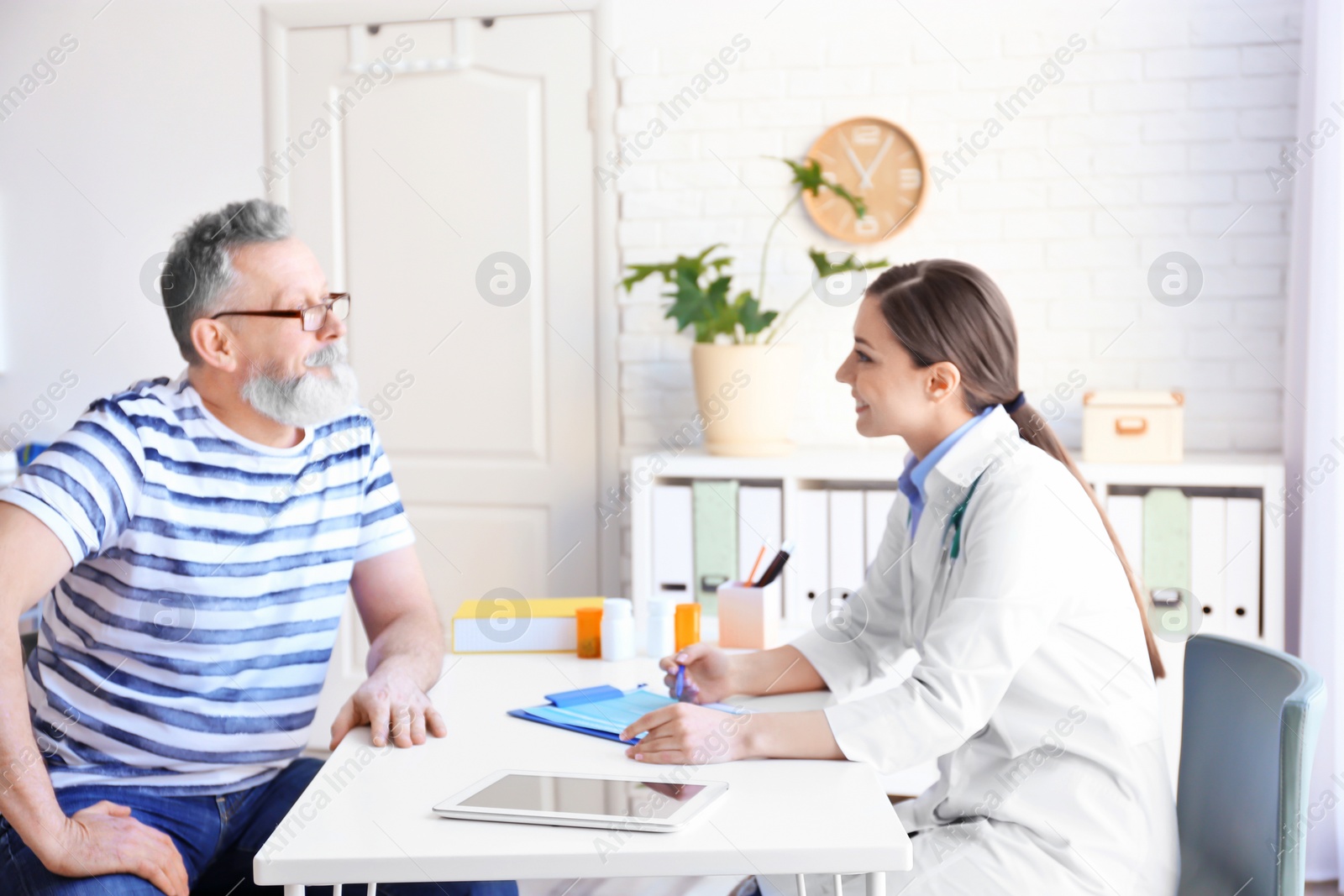 Photo of Female doctor consulting patient in clinic