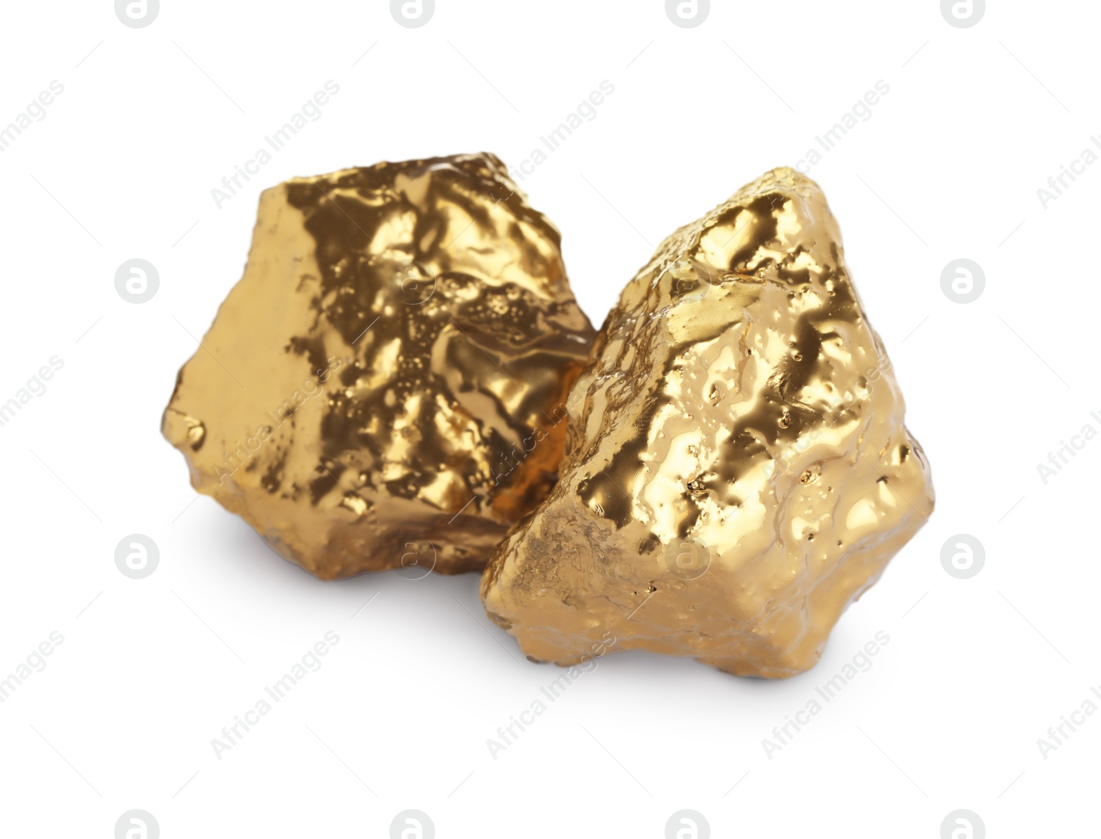 Photo of Two shiny gold nuggets on white background