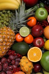 Photo of Different ripe fruits and berries as background, top view