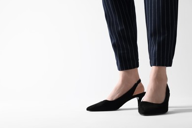 Photo of Businesswoman in black shoes on white background, closeup