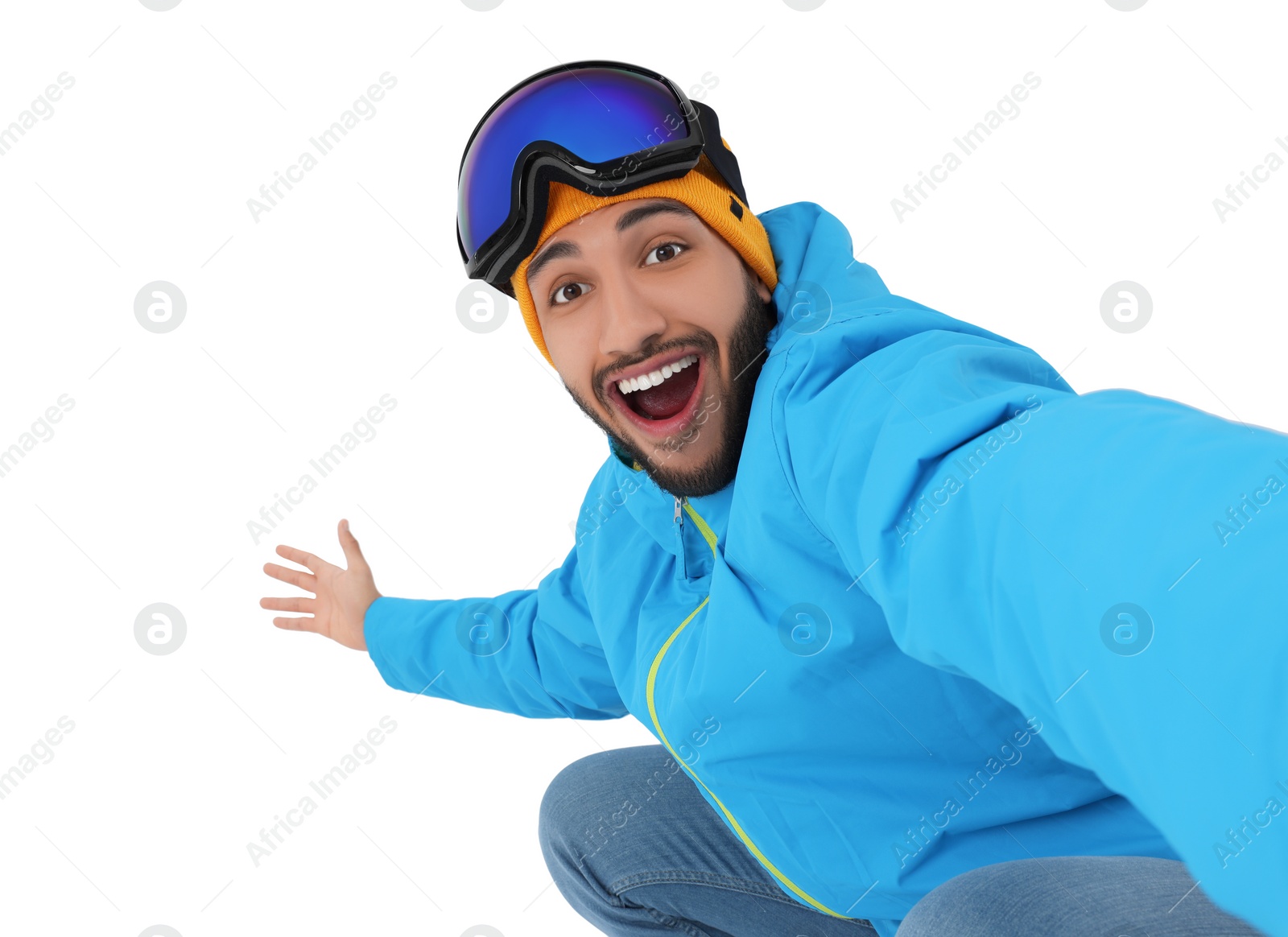 Photo of Smiling young man with ski goggles taking selfie on white background