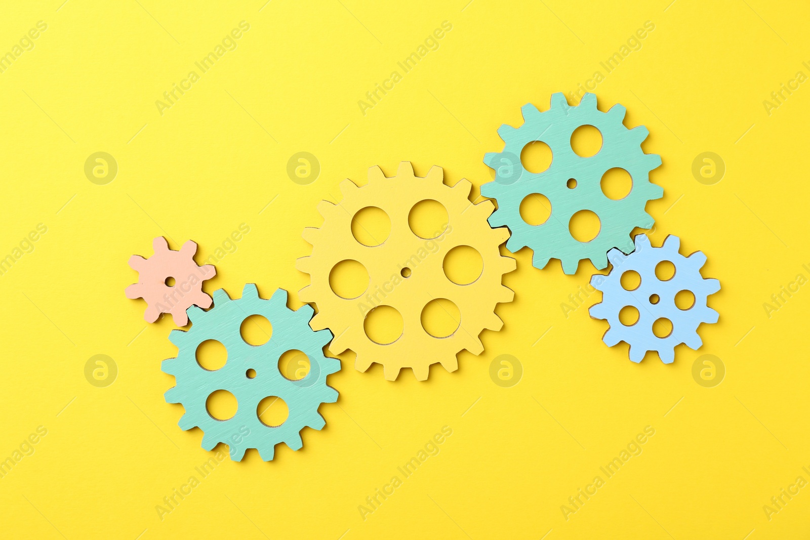 Photo of Business process organization and optimization. Scheme with colorful figures on yellow background, top view