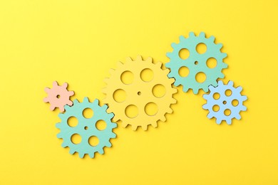 Photo of Business process organization and optimization. Scheme with colorful figures on yellow background, top view