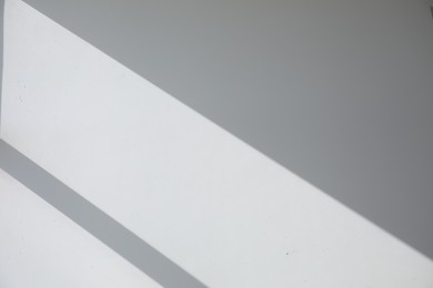 Photo of Shadow from window on white wall indoors