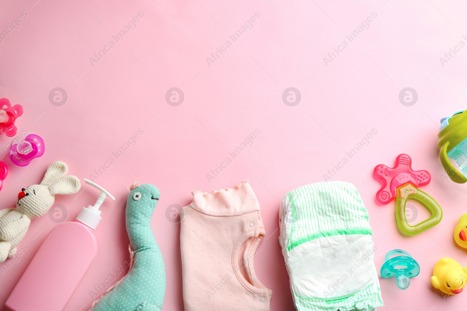 Photo of Flat lay composition with baby accessories and space for text on color background