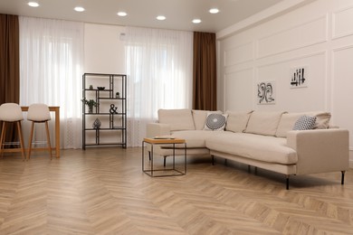 Photo of Modern living room with parquet flooring and stylish furniture