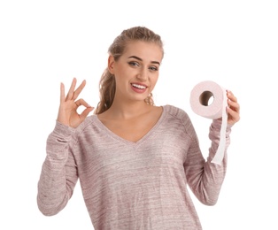 Beautiful young woman holding toilet paper roll on white background