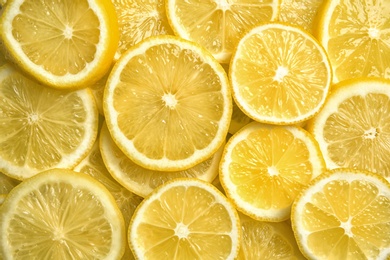 Photo of Slices of fresh juicy lemons as background