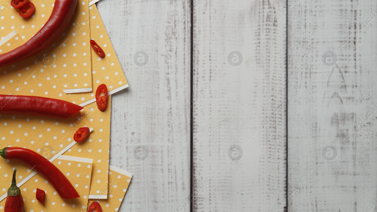 Photo of Pepper plasters and chili on white wooden table, flat lay. Space for text