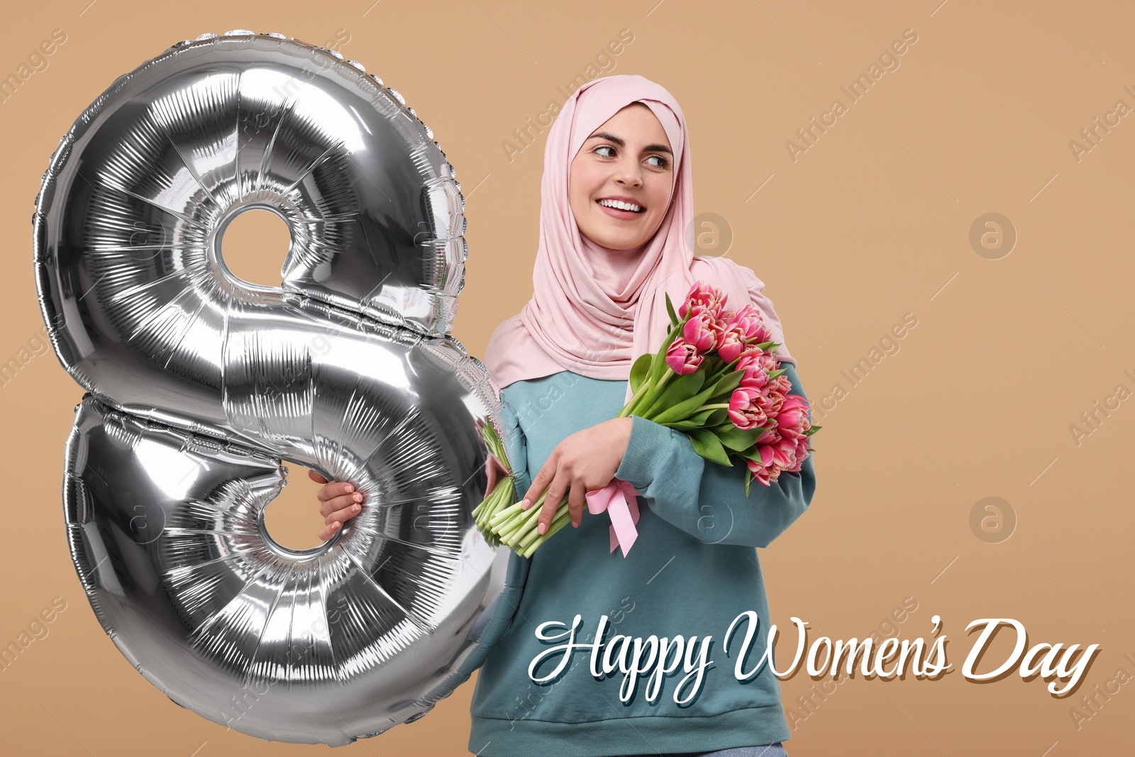 Image of Happy Women's Day - March 8. Attractive lady in hijab holding flowers and foil balloon in shape of number 8 on dark beige background