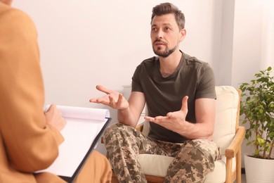 Psychologist working with military officer in office