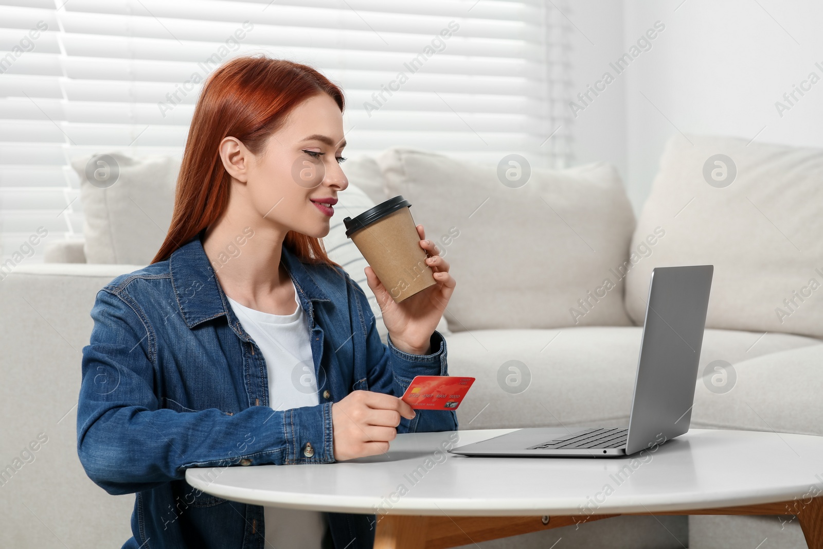 Photo of Happy woman with credit card near laptop at home, space for text. Online shopping