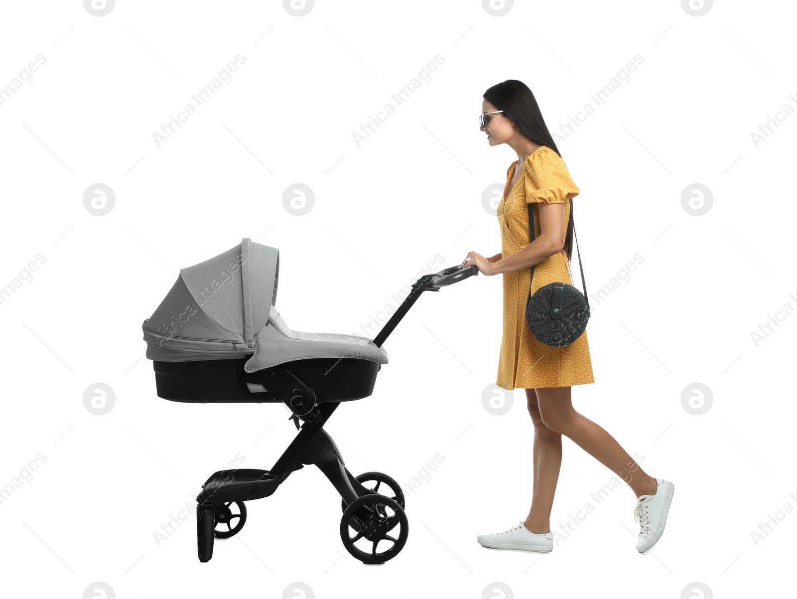 Photo of Happy young woman with baby stroller on white background