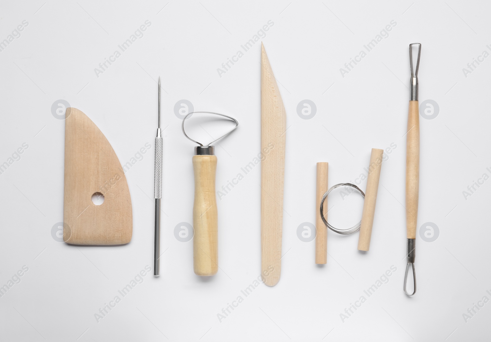 Photo of Set of clay modeling tools on white background, flat lay