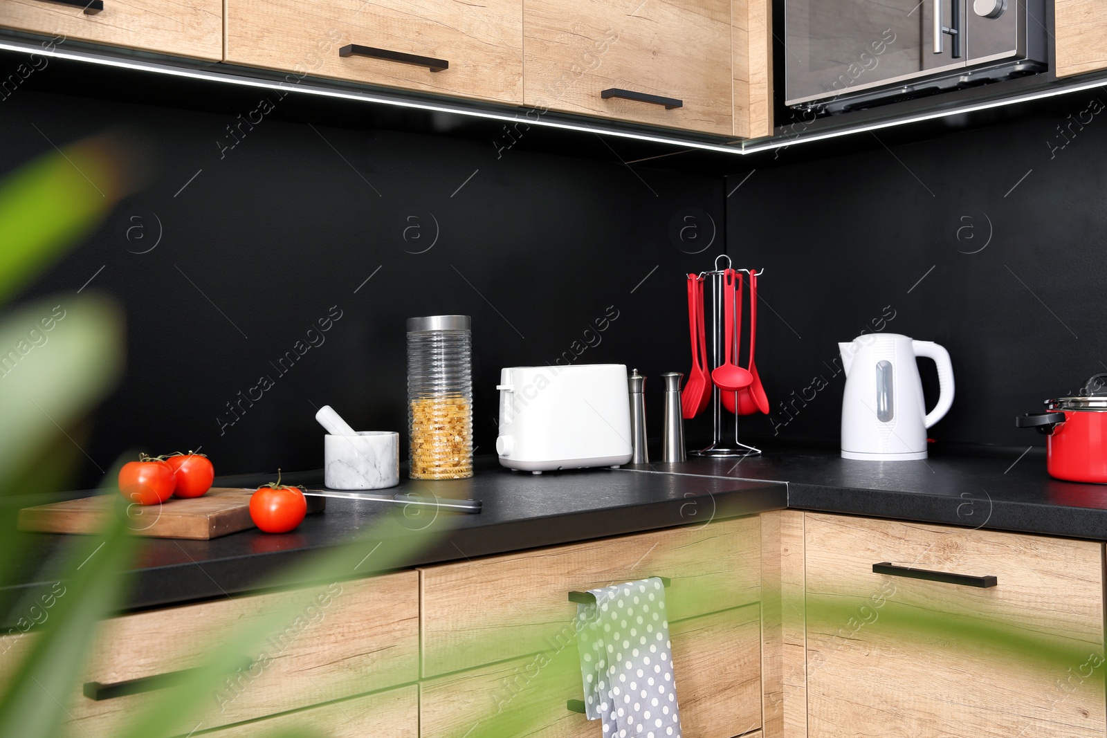 Photo of Kitchen interior with new furniture, appliances and houseware