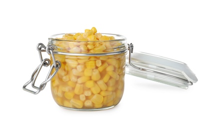 Photo of Open jar with pickled sweet corn on white background