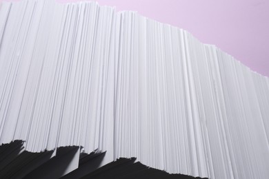 White paper sheets on violet background, closeup