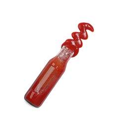 Photo of Ketchup and glass bottle isolated on white, top view